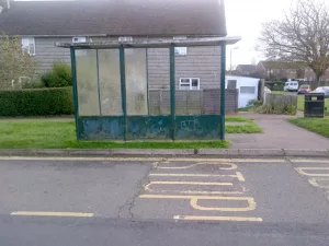 Green bus shelter before refurbishment